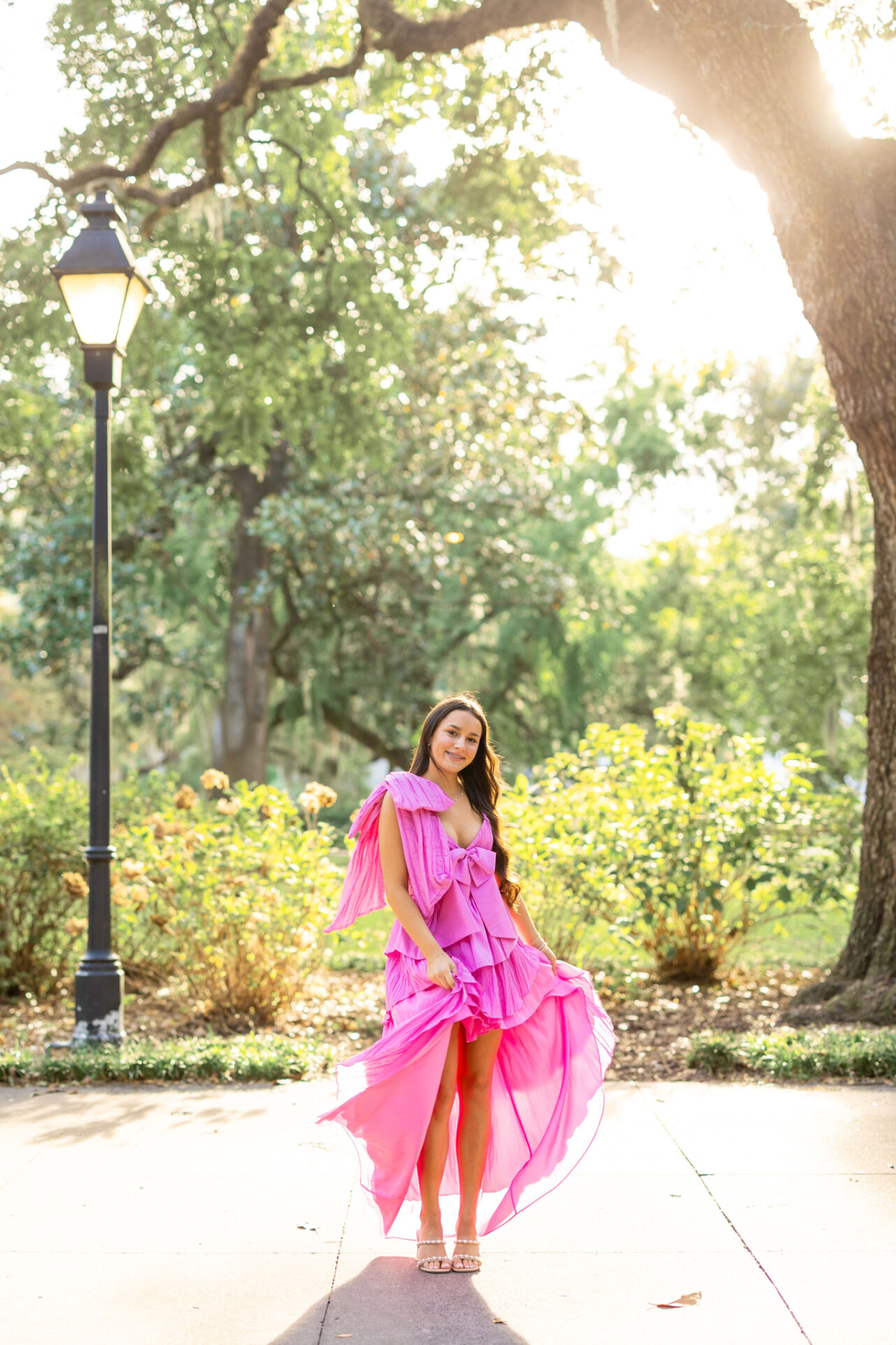 High School Girl in Forsyth Park, Savannah having her pictures done by Abi