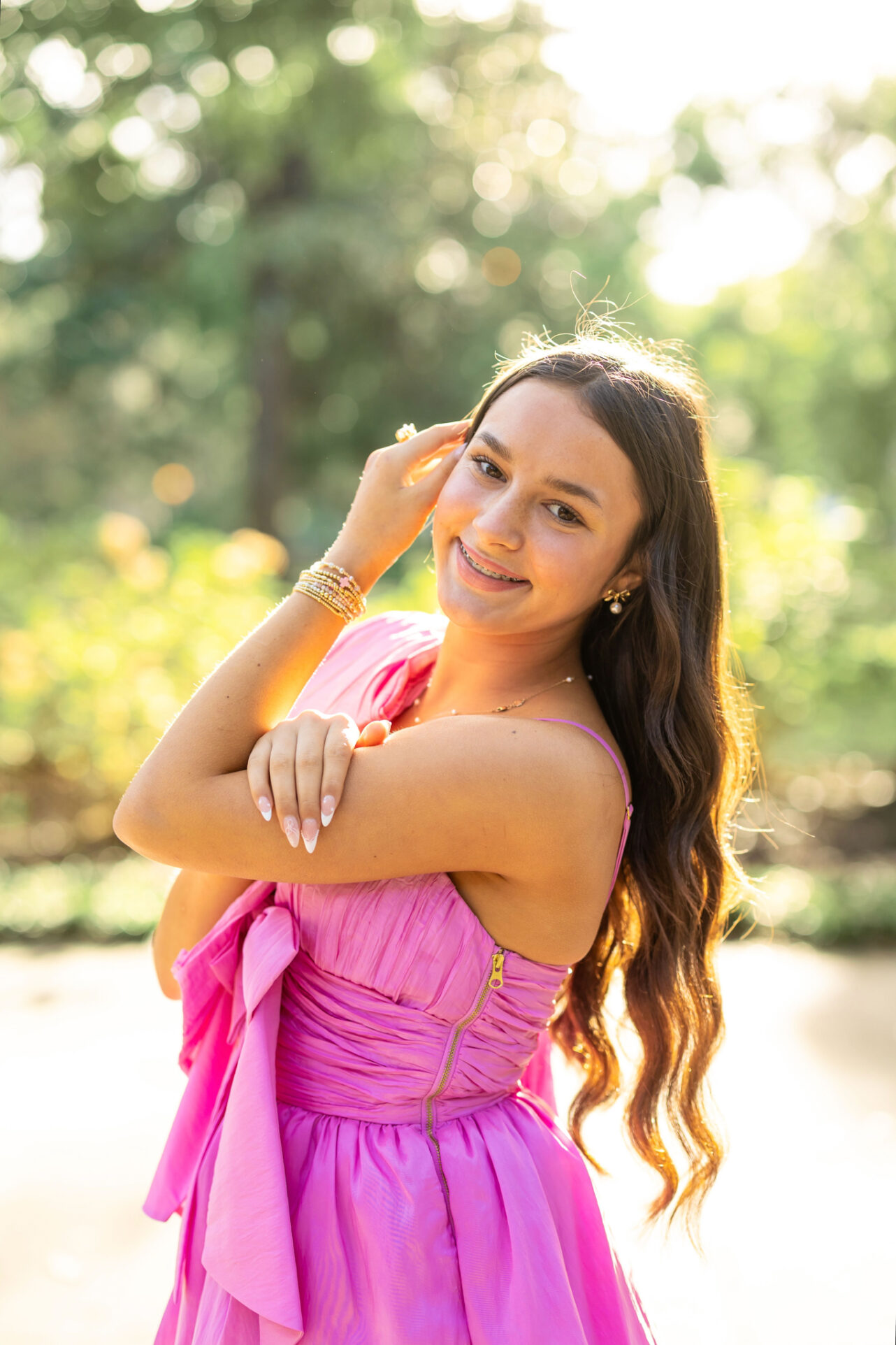High School Girl in Forsyth Park, Savannah having her pictures done by Abi